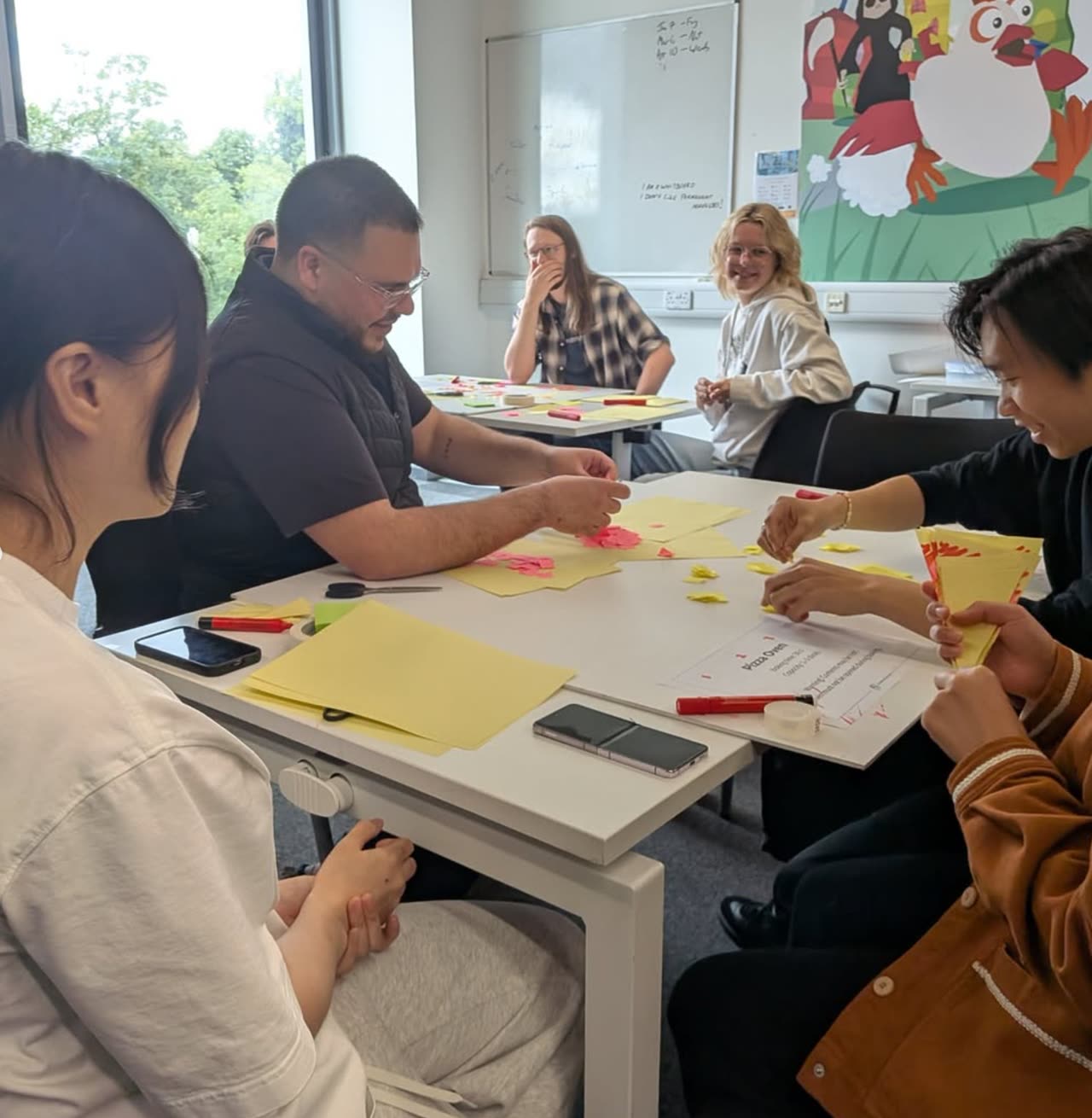 A group working through a planning exercise with sticky notes and index cards.